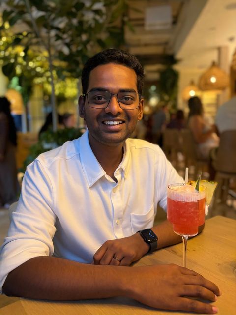 Prajwal Prathiksh smiling at a restaurant table